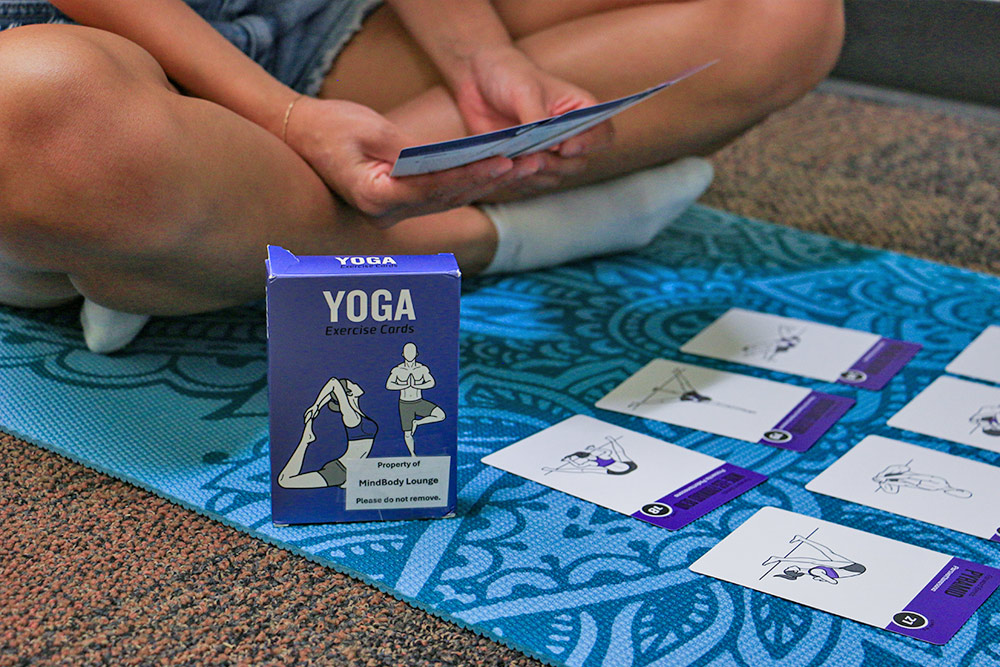 student looking at yoga cards