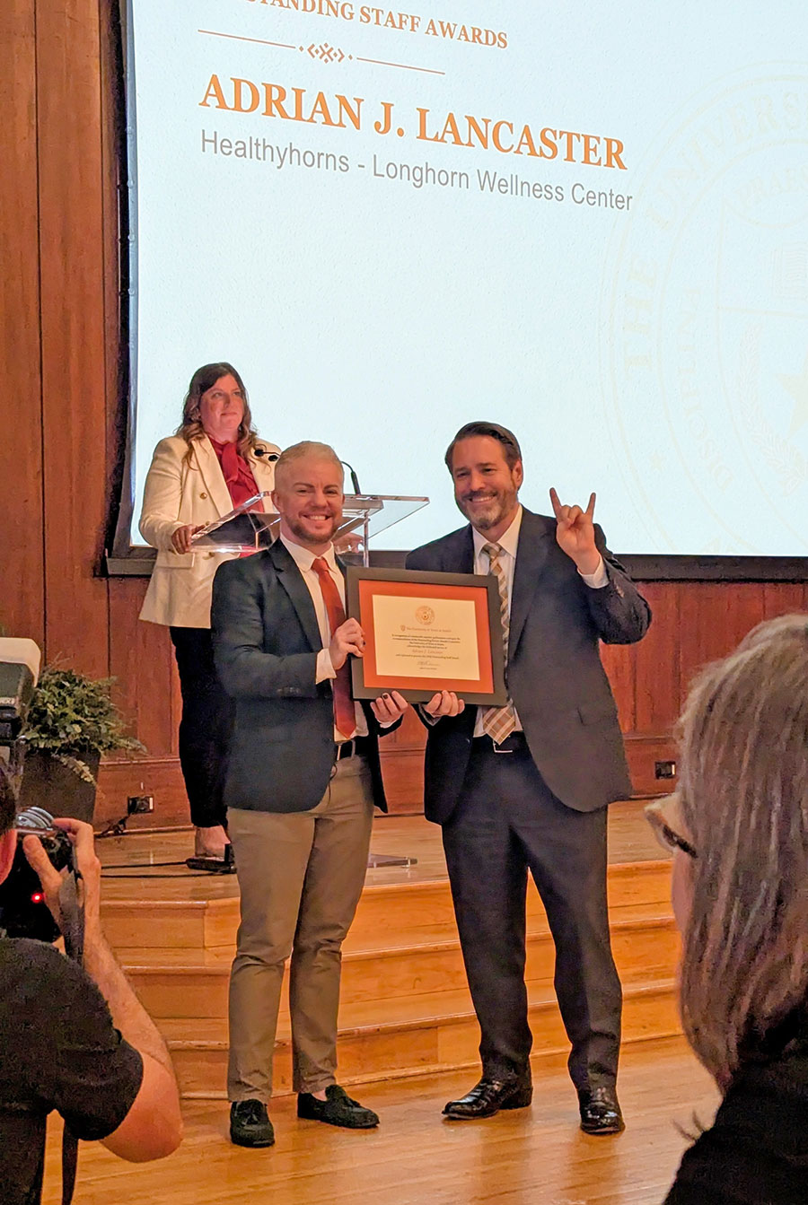 Adrian with President Jim Davis at the Outstanding Staff Awards ceremony, April 2026.