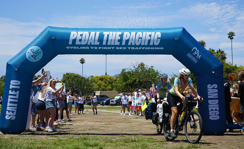 Glenn and a teammate arrive in San Diego, completing their ride from Seattle.